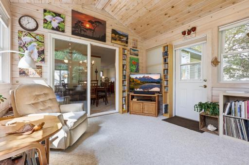 There is access to the backyard and and sliding door. The softly white washed woodwork is so calming.