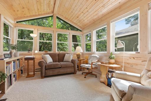 This sunroom off the living/dining room is beautiful. Such a relaxing spot, surrounded by trees and nature.