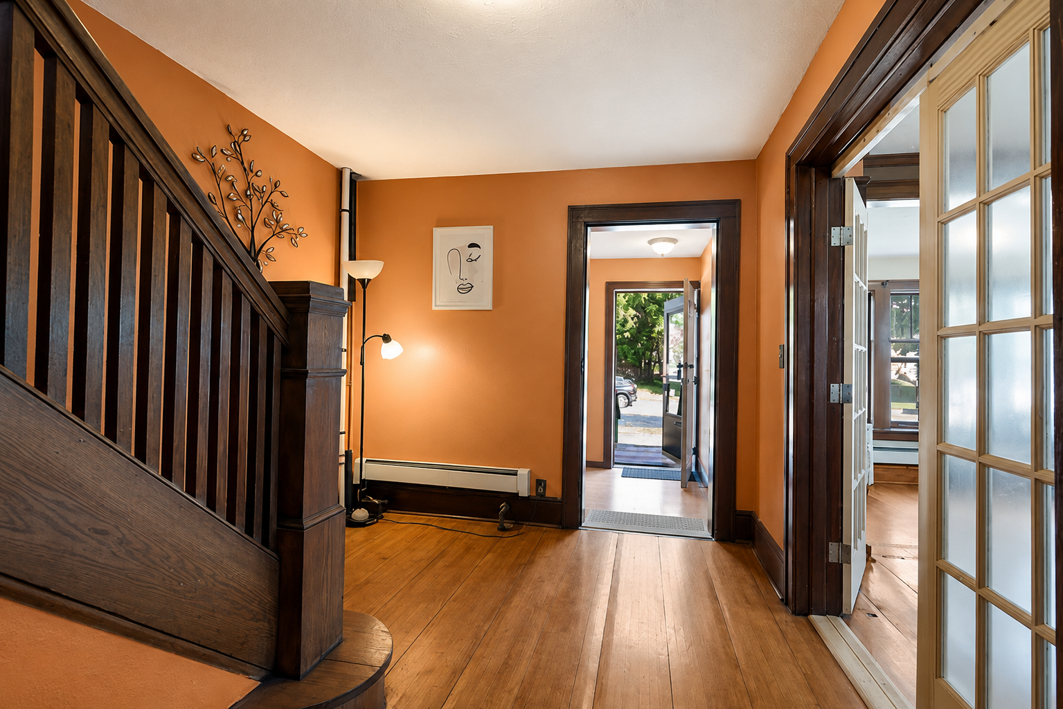 Beautiful and expansive foyer with natural Victorian woodwork.PNG