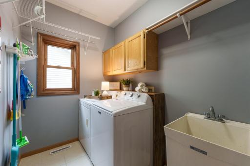Main level laundry room with utility sink!