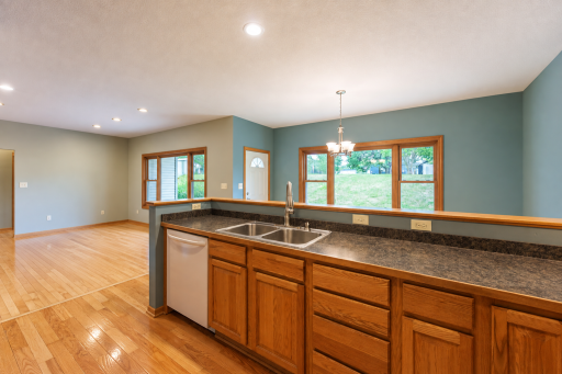 Open concept floor plan with bar-height counter creates an open connection between the kitchen and dining area yet hides dishes in the sink if you had a busy day.