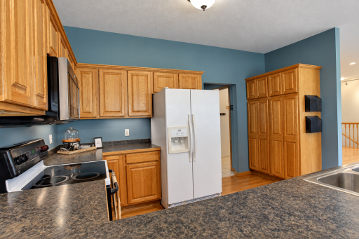 Check out that pantry cabinet! Doorway leads to laundry room, large coat closet & attached garage.