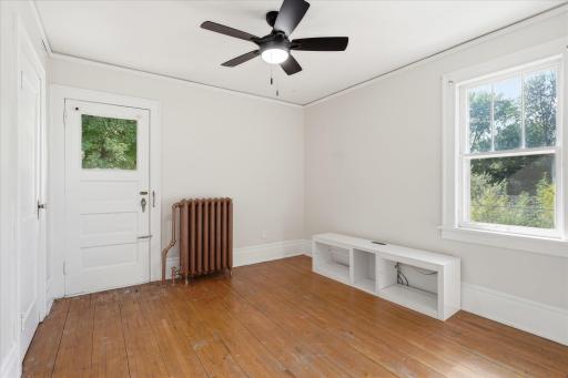 Second bedroom upstairs with access to small balcony over the mudroom.