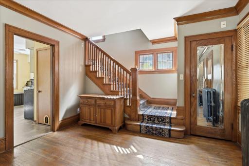 Come on in and view the original hardwood floors, high baseboards and all the beautiful wood accent trim.