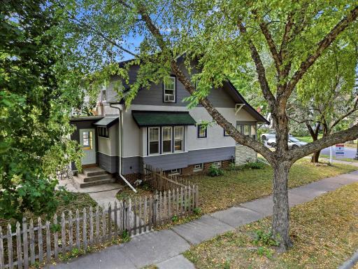 Backyard is fenced with picket fence on street side and chainlink fence between houses.