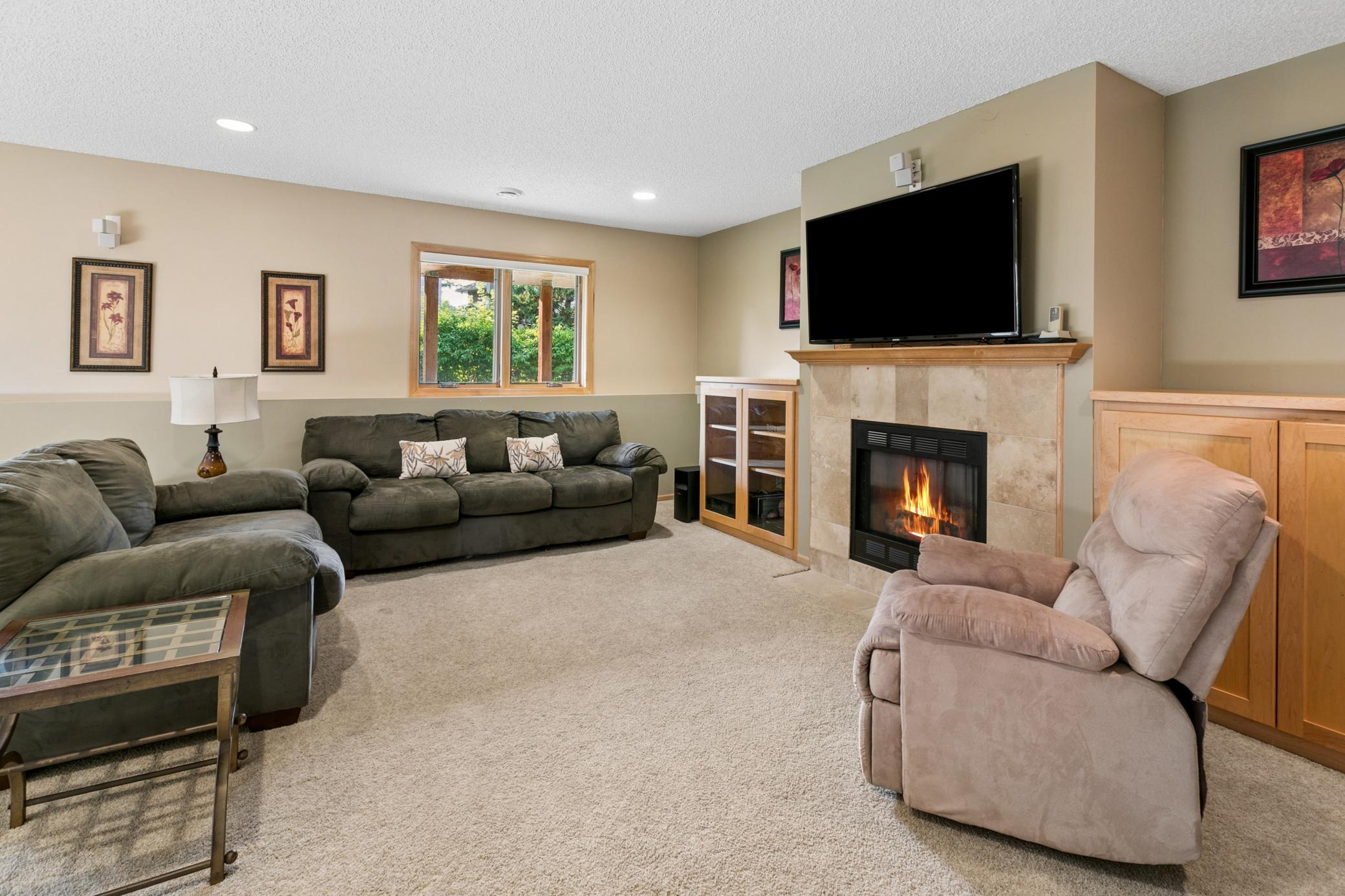 Lower level family room with another cozy gas fireplace.