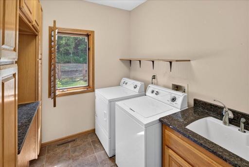 Main floor laundry with additional cabinet space for your convenience.