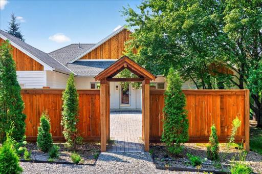 Step in to the impressive custom wood entry to your paver patio and front entrance.