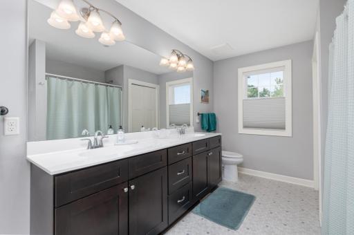 Very spacious upper level full bathroom with dual sink vanity. Includes a large linen closet for storage.