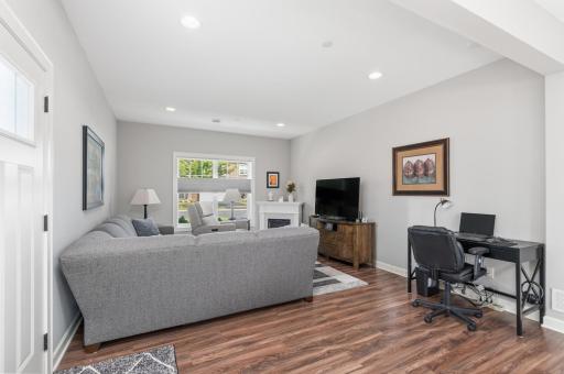 Main level featuring high ceilings, all new LVP flooring and spacious living, kitchen and dining spaces. There is even an area to set up a small main level work station.