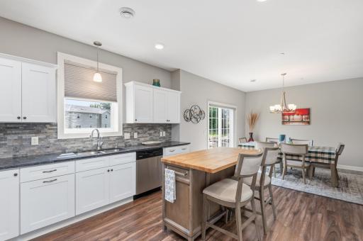 Entertain this holiday season with ease between the kitchen, informal dining, and living room. Also notice the large kitchen window with blind.