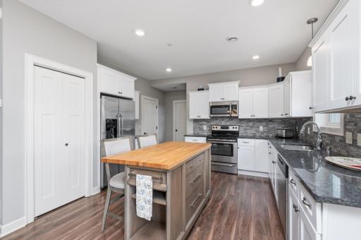 The current owners added the butcher block center island. The closet doubles as a coat closet and handy pantry for storage.
