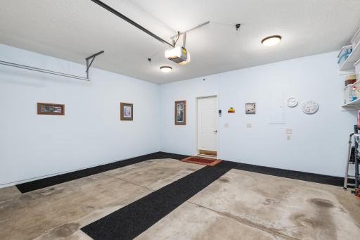Finished two car garage is clean and bright including knock down ceilings, shelves and extra lighting!