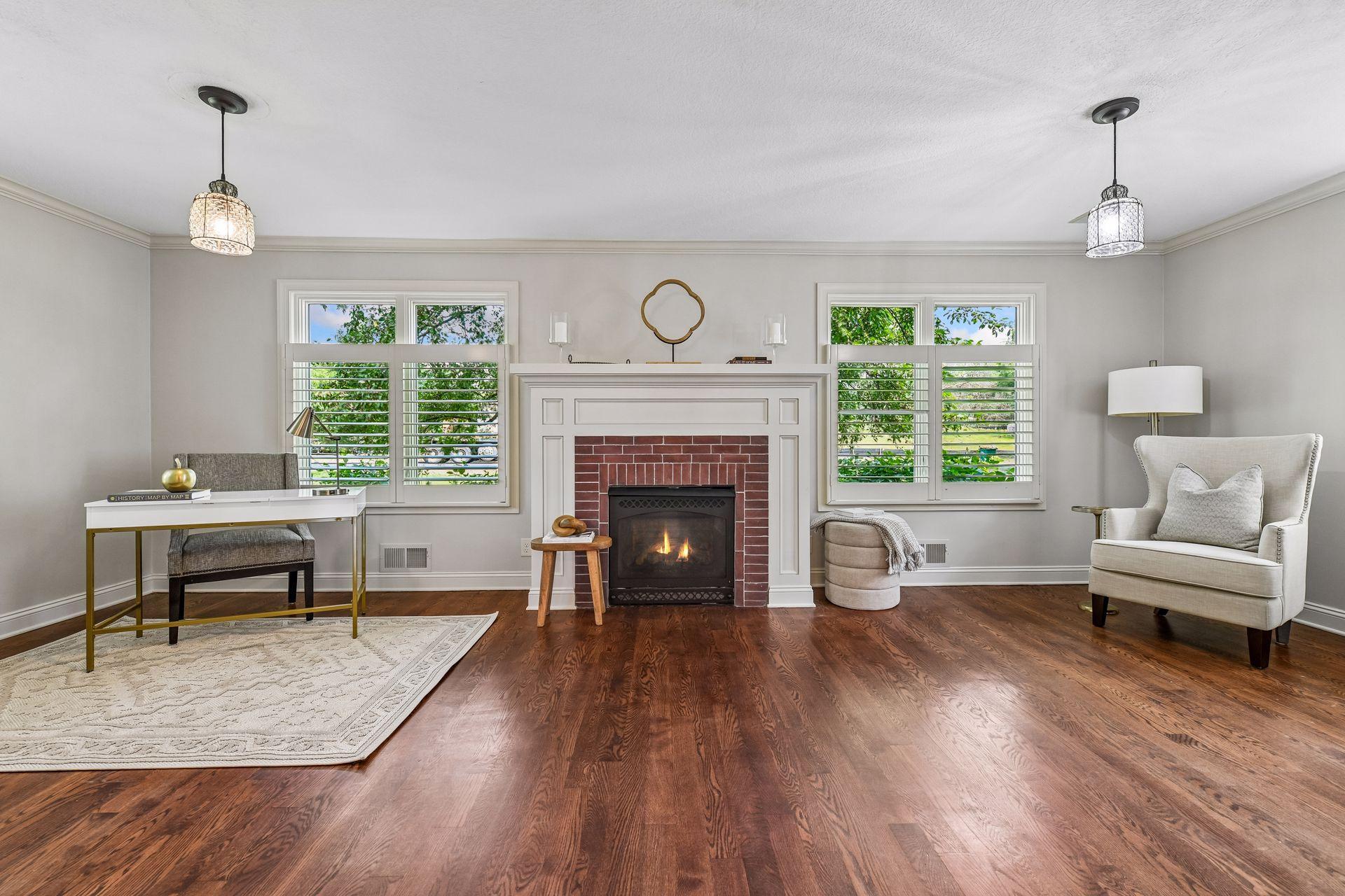 Spacious living room with brick fireplace and lovely mantle