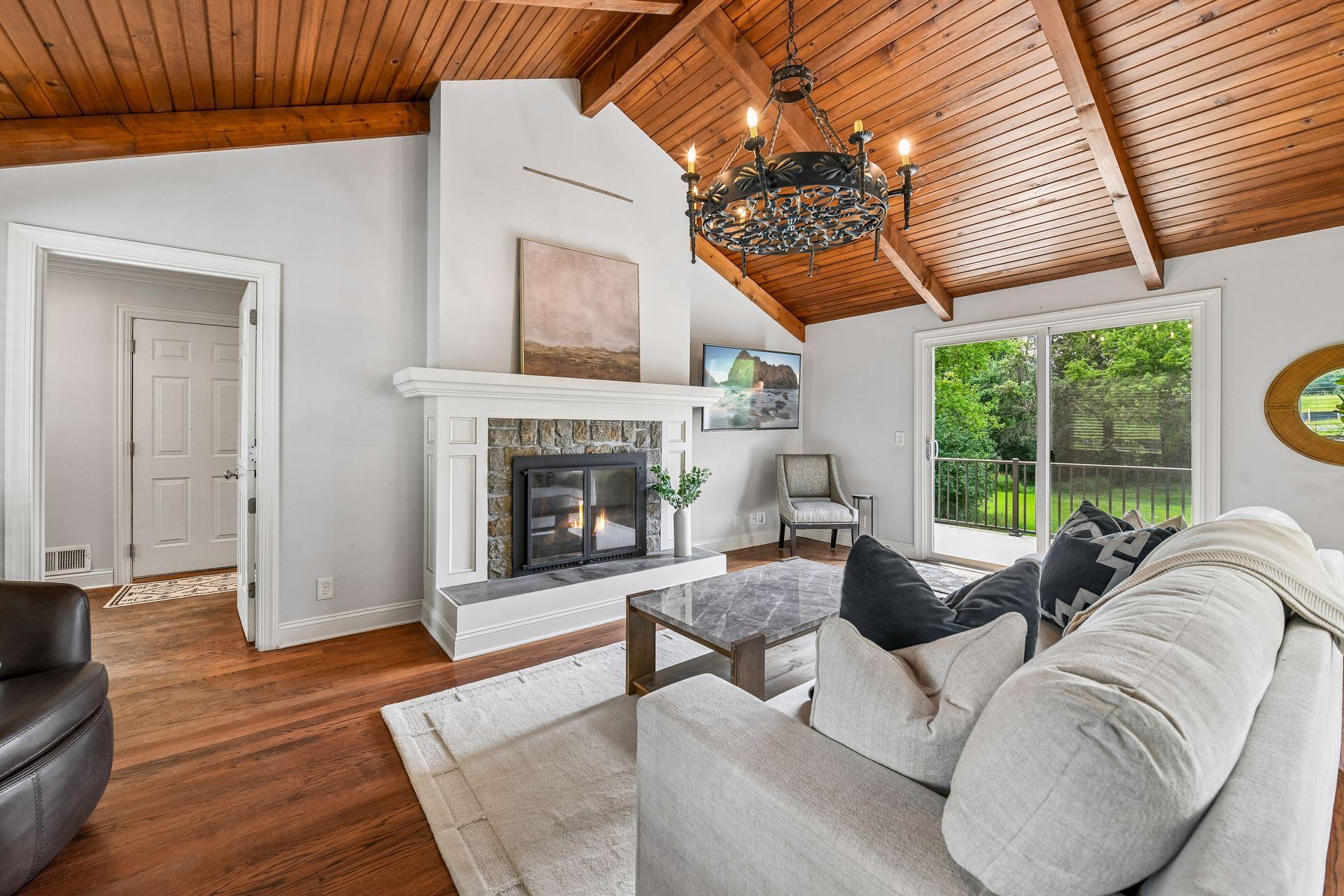 Floor to ceiling fireplace anchors this room