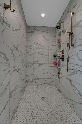 A beautifully designed, oversized walk-in shower provides a luxurious space to start and end your day, adding comfort and style to the private primary bath.