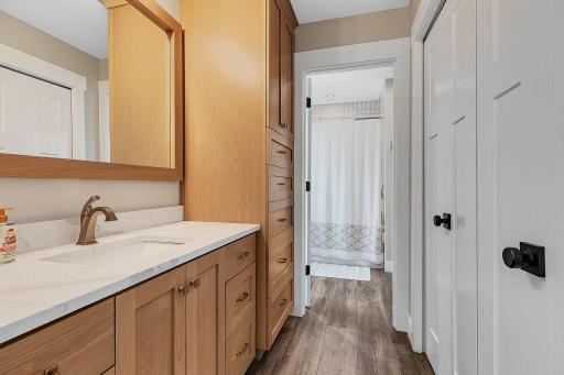 A private vanity area connected to one of the upstairs bedrooms provides a dedicated space to get ready, while the Jack-and-Jill layout offers convenient access to the shared bath.