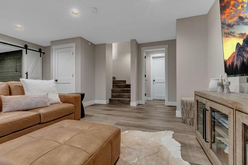 The lower level adds even more living space with another family room, two bedrooms, a large bathroom, and a dedicated office area.