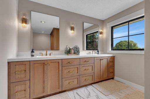 A private primary bath designed for everyday luxury, featuring dual vanities, tasteful modern finishes, and a bright, spa-inspired feel.
