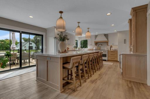 A luxurious kitchen featuring an oversized center island and beautiful views of the deck and poolâperfect for entertaining and enjoying indoor-outdoor living.
