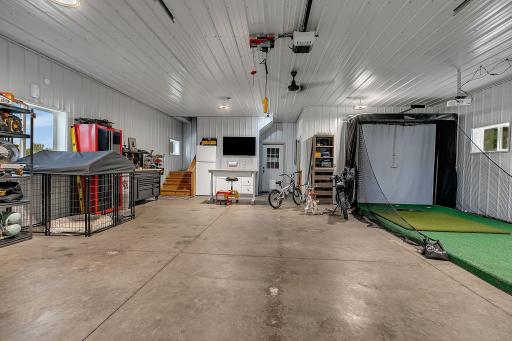 Nearly 1,000 square feet of climate-controlled space offers incredible flexibility for storage, hobbies, or recreation. Currently set up with ample storage and a golf simulator, this space can easily adapt to fit your needs.