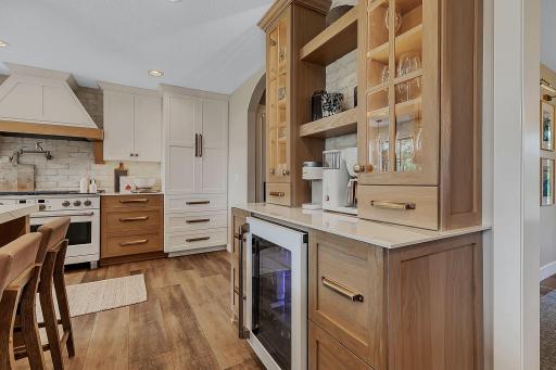 A beautifully designed coffee bar featuring custom cabinetry, elegant floating shelves, and a convenient beverage coolerâbringing style and function together for the perfect space.