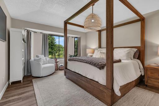 A spacious main-floor primary suite featuring beautiful bay windows, a custom walk-through closet, and a large private ensuite with a luxurious walk-in showerâcreating a comfortable and relaxing retreat.