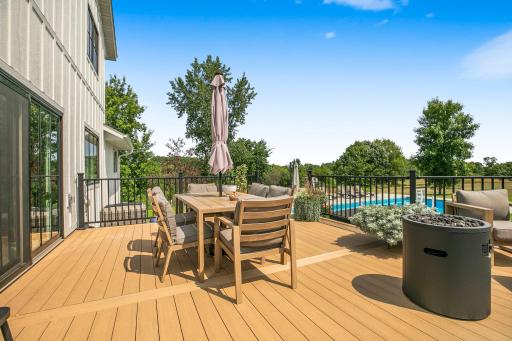 A beautiful maintenance-free deck overlooking the inground pool creates the perfect setting for relaxing, entertaining, and enjoying summer days at home.