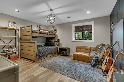 The first of two lower-level bedrooms is generously sized and features a beautiful accent wall and spacious walk-in closet.