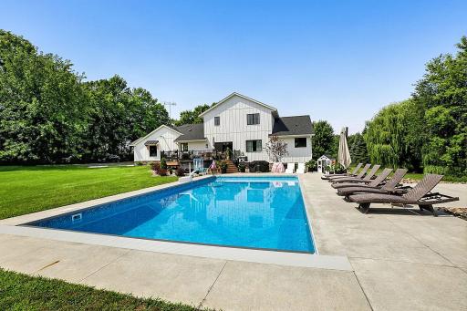 The spacious pool area has plenty of room for pool chairs and lounging, while the surrounding lawn provides even more space for outdoor games, activities, and enjoying time with family and friends.