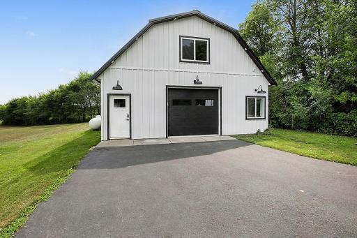 The updated exterior storage shed features a modern farmhouse design, offering tons of additional storage along with finished, versatile space that can be used for a variety of needs.