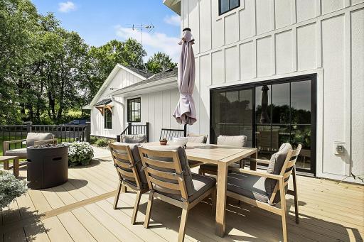 Another view of the spacious deck, which seamlessly connects to the kitchen through large patio doors, creating an easy flow between the indoor and outdoor living spaces.