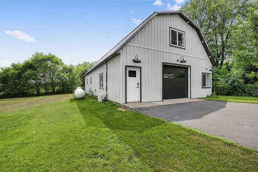 The outbuilding offers nearly 1,000 square feet of climate-controlled storage, 450 square feet of cold storage, and a finished upper level with an additional living room and gym.