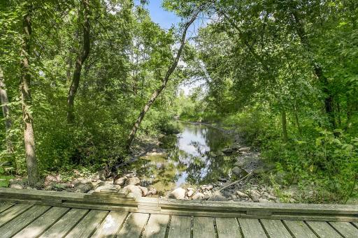 The property features a beautiful, peaceful stream that winds through the back of the property, adding to the natural beauty and tranquil setting.