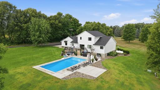 This beautiful 20-acre property has been completely renovated into a stunning farmhouse-style home, featuring luxurious living spaces, an inground pool, and an outbuilding with a second living room and full gym.