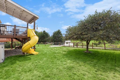 Spacious & fenced in yard with views of the community pond