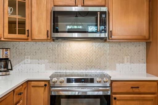 Gorgeous marble finish backsplash with herringbone pattern.