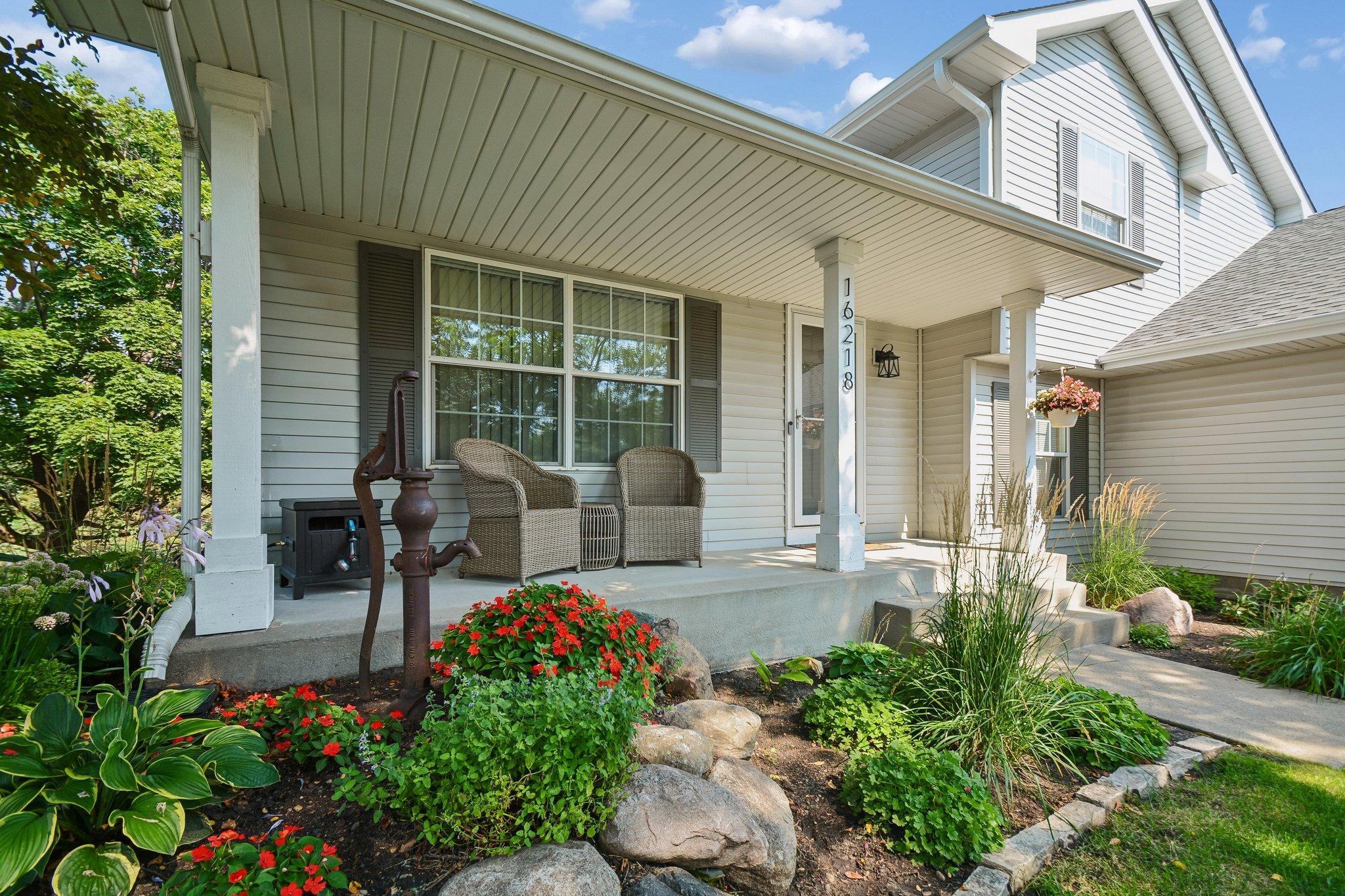 Enjoy the front porch and beautiful landscaping.ned withBeatifully la