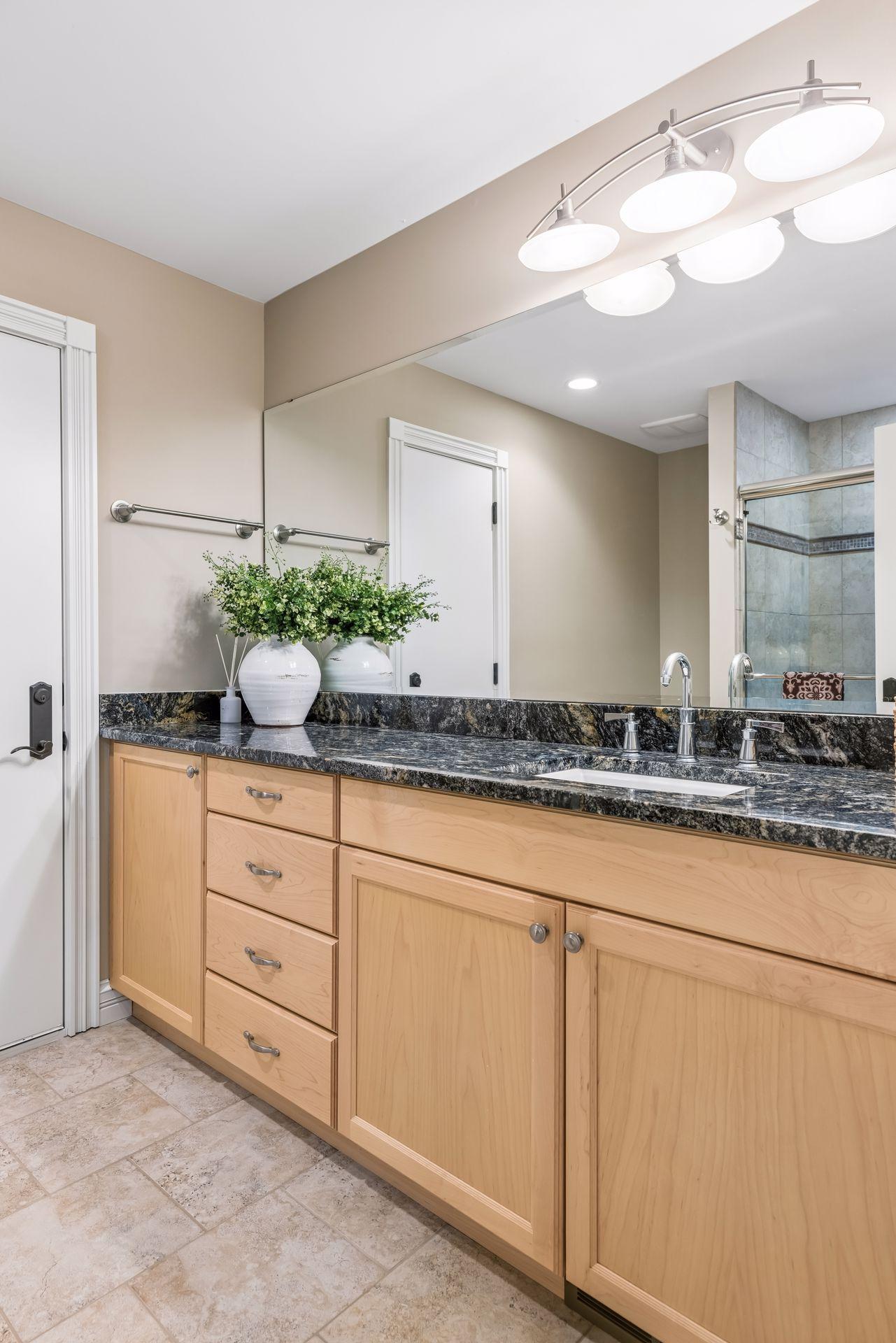 The bathroom attached to the upper-level bonus room features a large vanity with abundant storage.