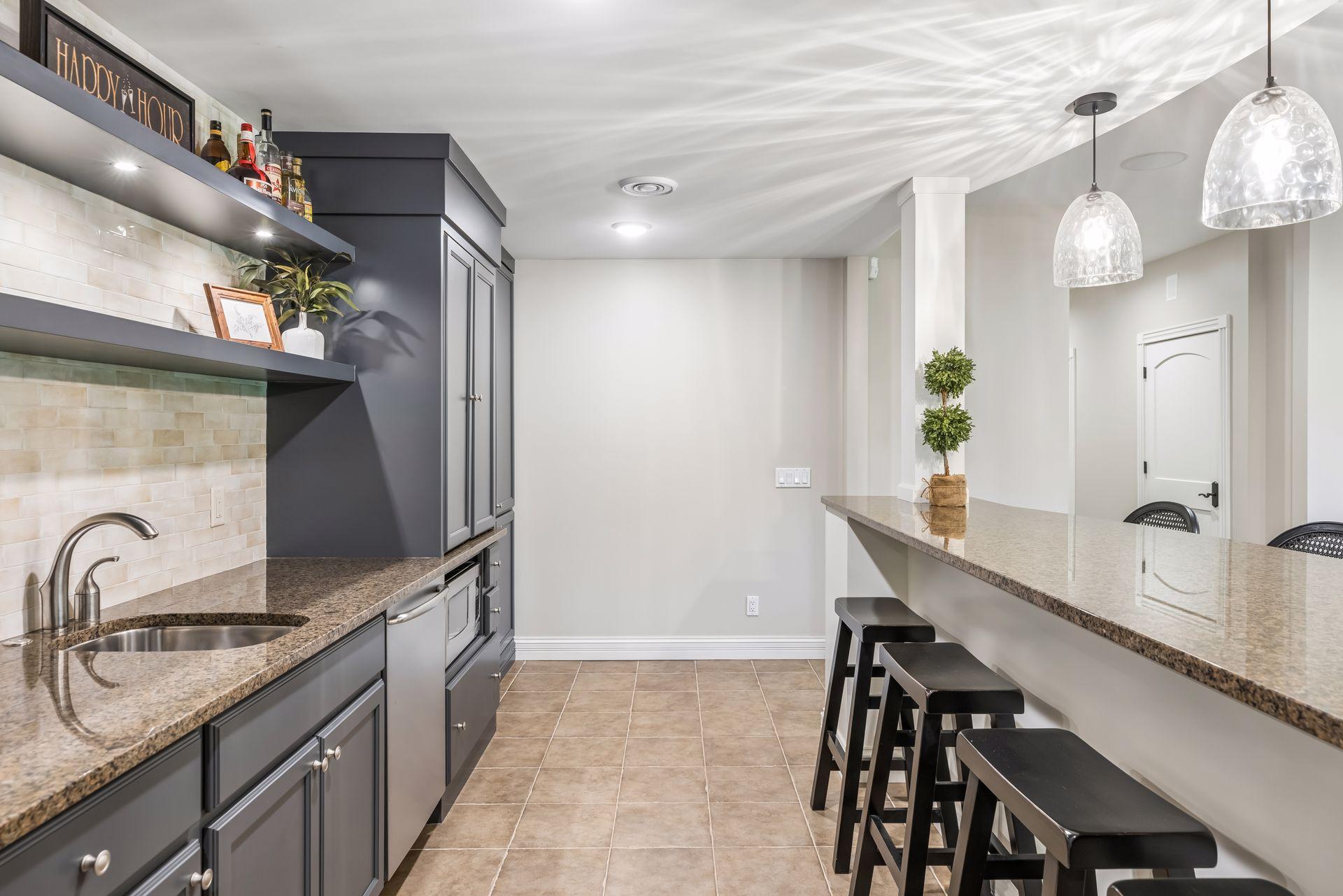 Dual overhangs on the bar create an inviting space where guests can sit, gather, and enjoy easy conversation.