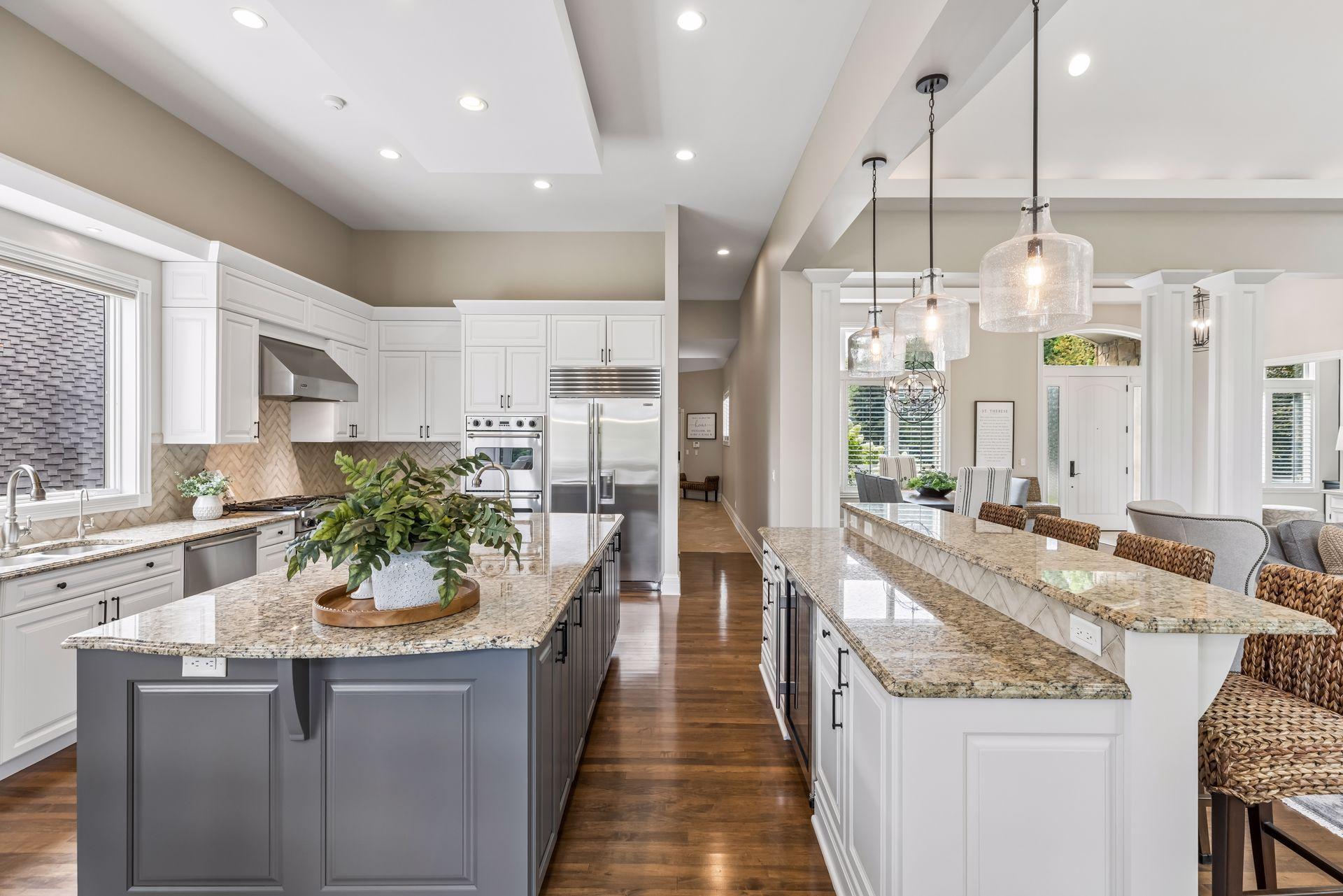 An open, spacious kitchen anchored by two large center islands.