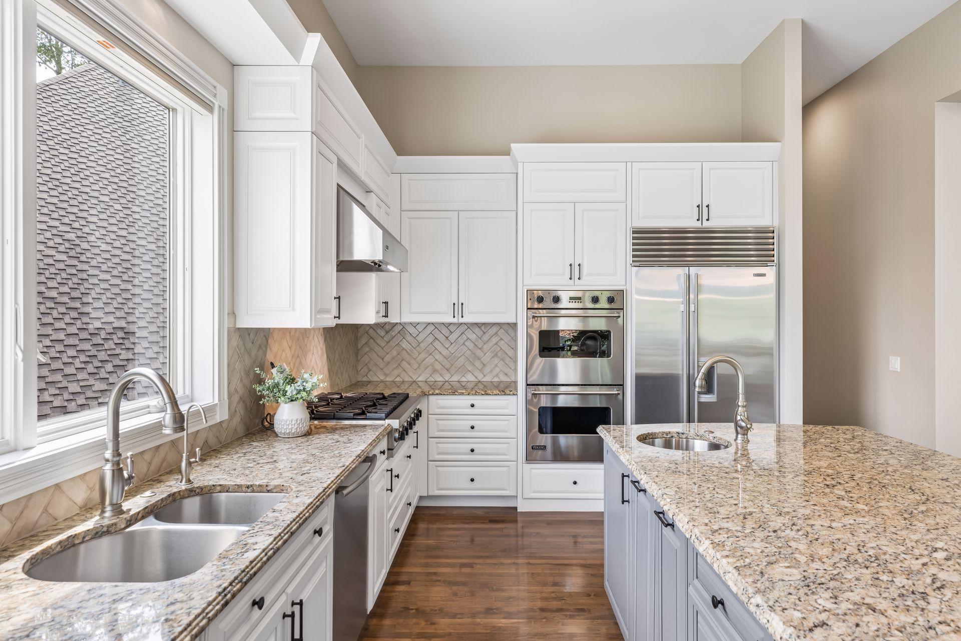 Granite countertops, stainless-steel appliances, and updated enameled cabinetry create a refined, modern look.