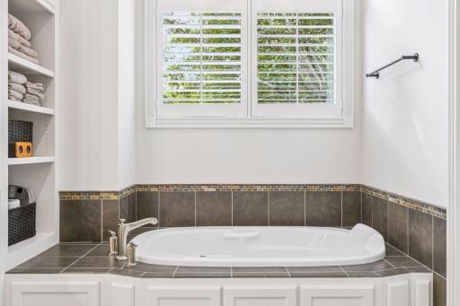 Soaking tub with convenient built-in shelving.