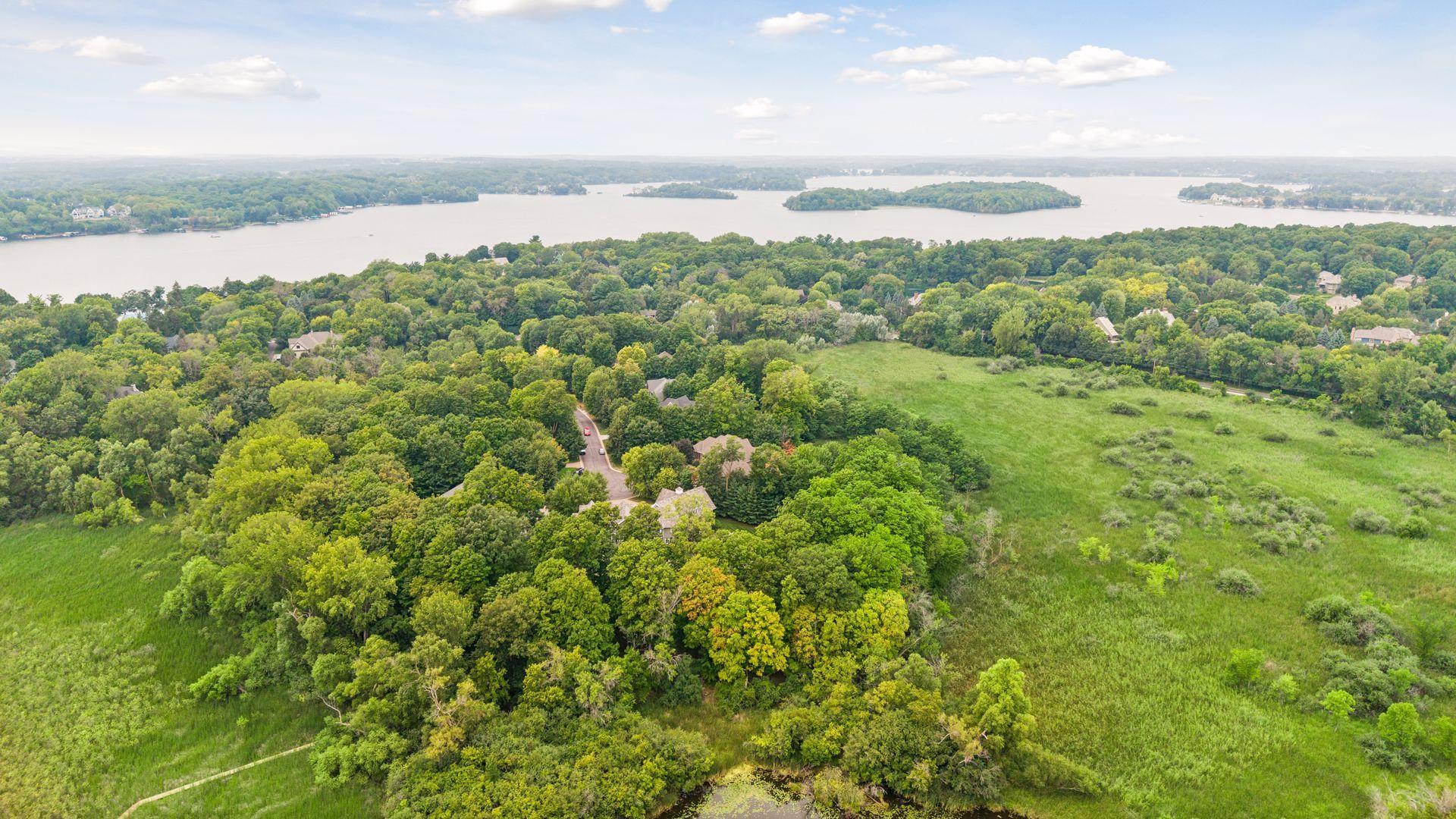 Aerial view showcasing the cul-de-sac, surrounding natural wetlands, and Smithtown Bay on Lake Minnetonka.
