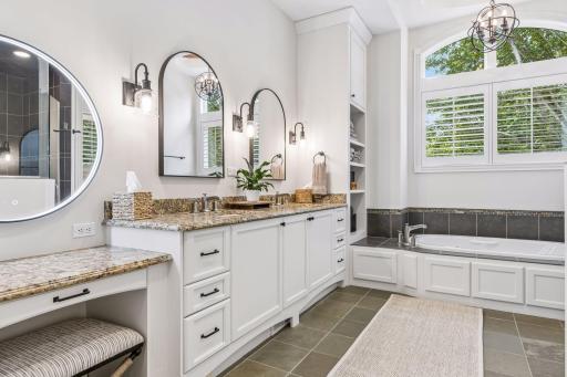A beautifully designed make-up vanity enhances the primary bathroom, offering a comfortable and convenient space for getting ready.