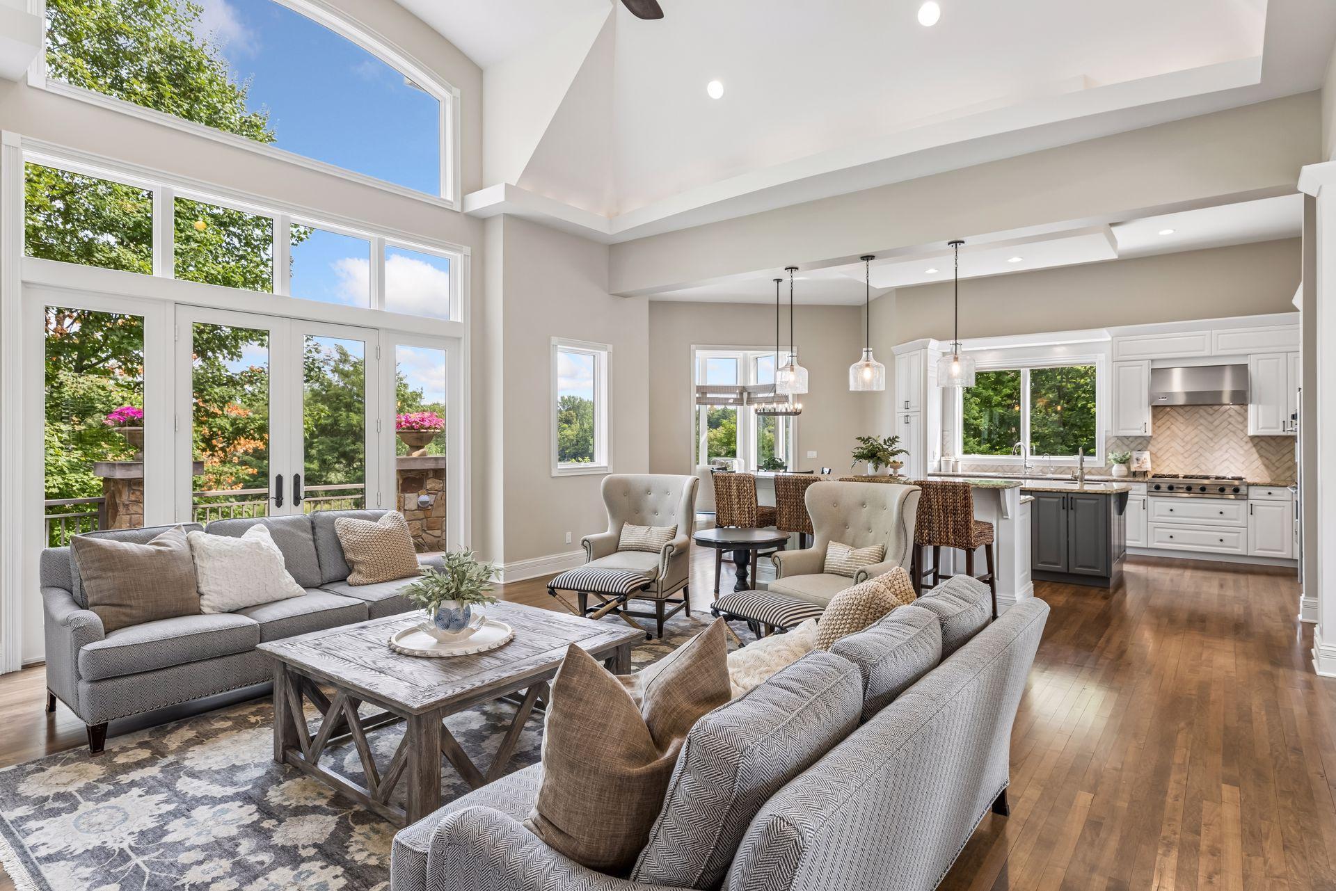 The main floor feels exceptionally bright and expansive, thanks to its soaring vaulted ceilings and dramatic, oversized windows.