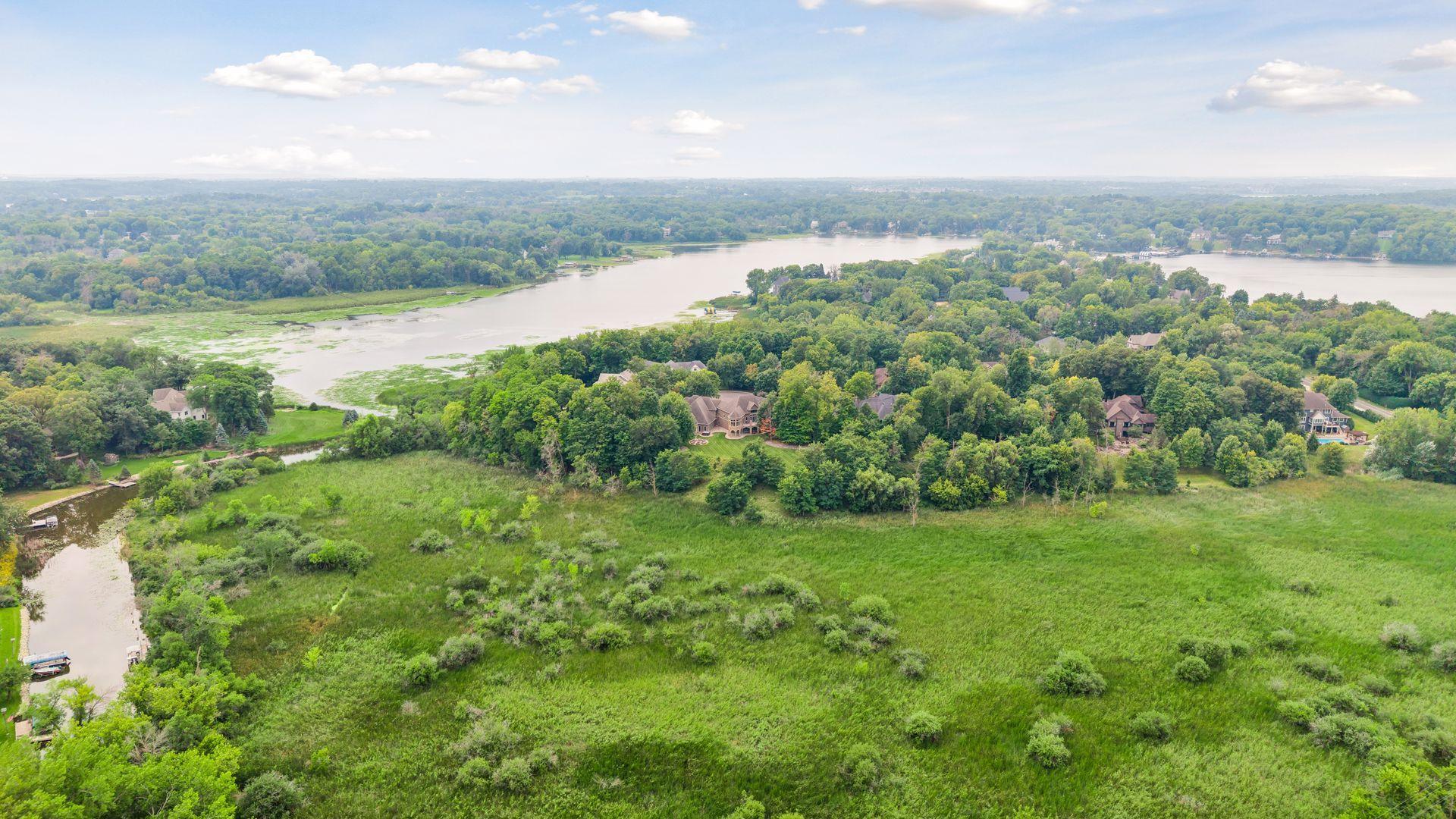 The property line reaches deep into the open natural wetlands, offering protected views and added privacy.