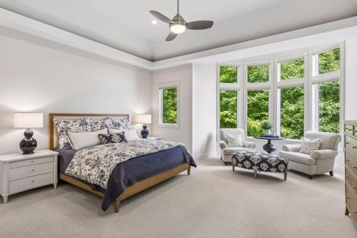 The spacious primary suite includes a beautifully appointed sitting area for relaxing and unwinding.