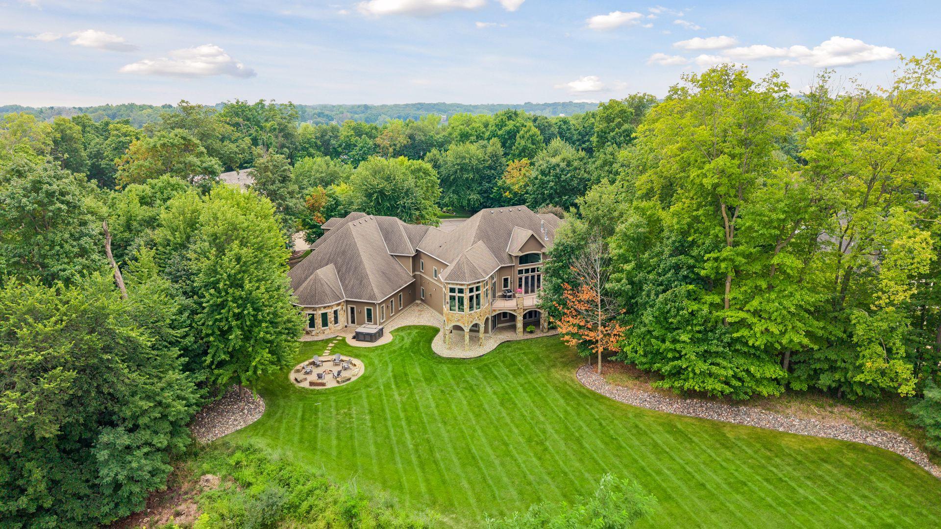 Large backyard surrounded by lots of trees and backing up to natural wetlands.