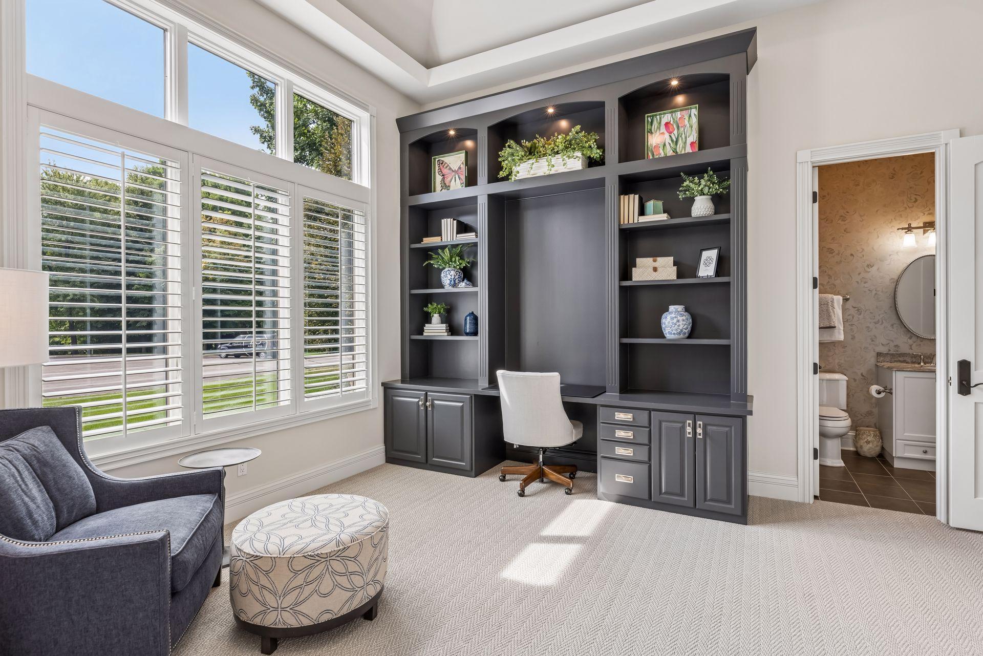 A beautifully appointed office off the foyer showcases custom built-ins for a refined, functional workspace.